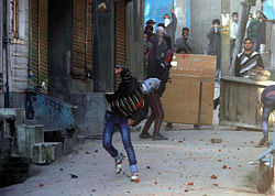 Kashmiri protesters throw stones on paramilitary soldiers during a spontaneous strike to protest the death of Kashmiri student Mudasir Qamran Malla in the Indian city of Hyderabad during the weekend, in Srinagar, India, Tuesday, March 5, 2013 The Kashmiri student was buried in his native village in the Pulwama district on Monday with the family rejecting the police claim that he had committed suicide. (AP Photo)