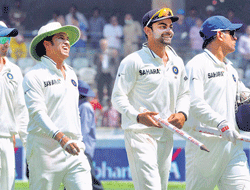 MS Dhoni leads the Indian players back after their victory over Australia in the second Test. PTI