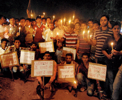 Allahabad: People take part in a candle light vigil for the slain Kunda DSP Zia-ul-Haq in Allahabad on Monday. PTI Photo