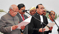 Governor H R Bhardwaj administers oath to Justice D H Waghela.