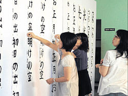 Japanese working on the calligraphy.