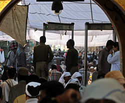 Police stand guard as devotees arrive at the Ajmer Sharif shrine in Ajmer on March 9, 2013. Pakistan's Prime Minister Raja Pervez Ashraf is arriving in India for a day-long pilgrimage at a time of strained relations between the neighbours after the recent tit-for-tat killings of soldiers on the border. AFP PHOTO