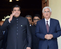 Pakistans Prime Minister Raja Pervaiz Ashraf gestures as he walks with Indian Foreign Minister Salman Khurshid, right, in Jaipur, India, Saturday, March 9, 2013. Ashraf is in India on Saturday on a daylong private visit to the shrine of Sufi saint Khwaja Moinuddin Chishti in the nearby town of Ajmer. Sufism is a more mystical form of Islam that is practiced in many parts of South Asia. (AP Photo)
