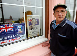 Bill Poole aged 85, Falkland Islander, stands on March 7, 2013 in Port Stanley, beside posters calling to vote YES to remain British in the referendum which will be held on the Falklands Islands (Malvinas, for Argentina), on March 10 and 11, asking the islanders whether they wish to retain their status as a self-governing British overseas territory. Argentina says the vote is illegal. Great Britain has held the islands since 1833, but Argentine forces invaded them in 1982, prompting then British prime minister Margaret Thatcher to send ships and troops to reclaim control. The 74-day war left 649 Argentines and 255 Britons dead. AFP PHOTO