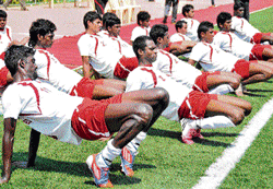 Gearing up: South United FC players limbering up on the eve of their  match against Luangmual FC at the Bangalore Football stadium on Sunday. dh photo/ bk janardhan