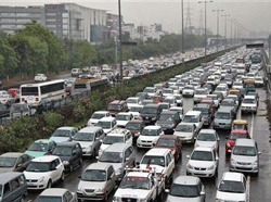 Heavy traffic moves along a busy road as it rains during a power-cut at the toll-gates at Gurgaon on the outskirts of New Delhi July 31, 2012.  Credit: Reuters