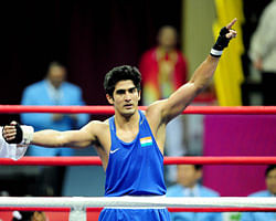 (FILES) In this photograph taken on November 26, 2010 Vijender Singh of India salutes after beating Abbos Atoev of Uzbekistan during the men's 75kg boxing final competition against Zhang Jiawei of China at the 16th Asian Games in Guangzhou. Indian police said March 10, 2013 it will question the 2008 Olympic bronze-medallist boxer Vijender Singh over alleged links to a man who was arrested after heroin worth 24 million USD was seized from his house. AFP PHOTO