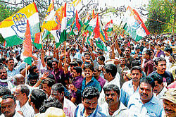 Ecstatic: Supporters of Congress party rejoice the victory of their candidate in Mysore on Monday. DH Photo