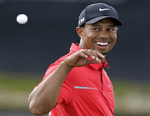 Tiger Woods looks back to catch a ball after his caddie cleaned it on the eighth green during the final round of the Cadillac Championship golf tournament on Sunday, March 10, 2013, in Doral, Fla. Woods won the championship. AP Photo