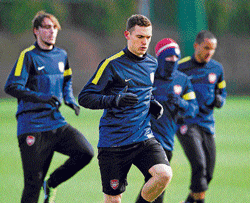 raring to go: Arsenal's Thomas Vermaelen warms up during a training session in London on Tuesday ahead of his teams Champions League match against Bayern&#8200;Munich. AFP