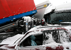 Wrecked vehicles are pictured following an accident on highway A45 between Giessen and Hanau near the city of Woelfersheim, March 12, 2013. More than 100 vehicles were involved in a multiple pile-up on Tuesday after they crashed on the snowy highway, police at the scene said. Several people were injured in the incident. REUTERS