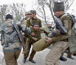 Indian paramilitary soldiers carry their injured colleague to a hospital during a gunfight in Srinagar March 13, 2013. Two militants wielding automatic rifle opened fire on a paramilitary camp on the Indian side of the disputed region of Kashmir on Wednesday, killing five Indian personnel and wounding five, police said.  Credit: Reuters