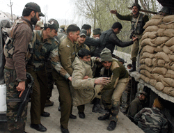 Security personnel rush an injured jawan to a hospital after militants attacked a CRPF camp in Bemina area of Srinagar on Wednesday. PTI Photo