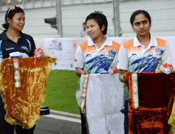 Cyclists Manorama Devi (C), Sunita Devi (L) and Anjana carrying medal trays at the felicitation ceremony at the Asian Cycling Championships in Greater Noida on Wednesday. PTI Photo