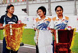 shocking treatment: (From left) Indian cyclists Manorama Devi, Sunita Devi and Anjana carry the medals tray during the Asian Championships on Wednesday. pti
