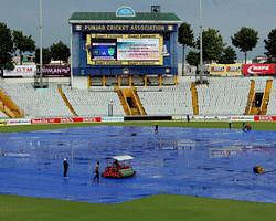 Ground man clear pitch during the 3rd test match against Australia start delayed due to rain PCA Stadium in Mohali on Thursday. PTI Photo