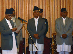 Nepal's President Ram Baran Yadav (R) observes as newly-appointed Prime Minister Khil Raj Regmi (L) administrates his oath at the Presidential House in Kathmandu March 14, 2013. Nepal's chief justice took over as the head of an interim unity government on Thursday, the country's main political parties said, a move aimed at ending a political deadlock in a nation still recovering from a decade of civil war. Regmi replaced Maoist Prime Minister Baburam Bhattarai under an agreement signed by the four major political parties and will head the new administration until a national election is held in either May or June. REUTERS