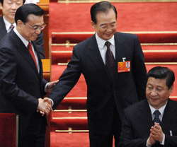Newly-elected Chinese Premier Li Keqiang (L) and former premier Wen Jiabao (C) look at Chinese President Xi Jinping(R) as they shake hands each other during the 12th National People's Congress (NPC) in the Great Hall of the People in Beijing on March 15, 2013. China's parliament installed bureaucrat Li Keqiang as premier on March 15, putting him in charge of running the world's second-largest economy in a final step of a landmark power transition. AFP PHOTO