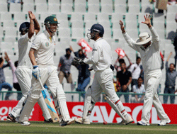 Indian players celebrate the dismissal of Australia's Michael Clarke during the second day of 3rd cricket test match in Mohali on Friday. PTI Photo
