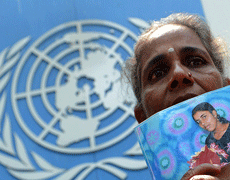 A Sri Lankan demonstrator holds a portrait of a missing relative during a protest outside the United nations office in Colombo on March 13, 2013. A Roman Catholic priest led families of victims to hand over a petition to the UN office as Sri Lanka faced renewed censure at the on-going UN Human Rights Council (UNHRC) sessions in Geneva. Priest Sebamalai Emmanual said hundreds of minority Tamils were stopped from leaving the northern town of Vavuniya a week ago by police and security forces who blocked a planned peaceful demonstration in the capital. AFP PHOTO