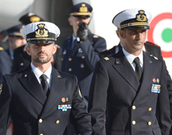 (FILES) This photograph taken on December 22, 2012, Italian marines Massimiliano Latorre (R) and Salvatore Girone (L) arrive at Ciampino airport near Rome. India's Supreme Court on March 14, 2013, issued an order to Italy's ambassador to stay in the country for four days amid a dispute over two Italian marines who skipped bail while on trial in New Delhi. Rome announced on March 11, that Massimiliano Latorre and Salvatore Girone, who face murder charges over the death of two Indian fishermen in February last year, would remain in Italy. AFP PHOTO