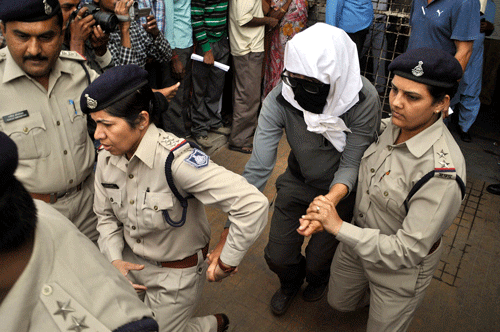 A Swiss woman, center, who was gang raped by a group of eight men while touring by bicycle with her husband, is escorted by policewomen for a medical examination at a hospital in Gwalior, Madhya Pradesh, on Saturday. PTI Photo