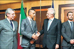 File photo of Italian Premier Mario Monti (second from right) shaking hands with marine Massimiliano Latorre, who is on murder trial in India along with fellow marine Salvatore Girone (right) for shooting dead two Indian fishermen off the Kerala coast, mistaking them for pirates.