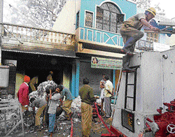 The fire at a shop in Bangarpet on Friday is doused by staff of the fire brigade. dh photo