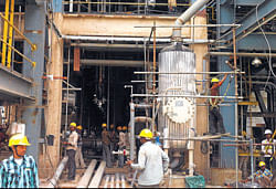 Work in progress on the coal-to-liquid gasification plant at Jindal Steel & Power Ltds (JSPL) plant in Angul, Odisha. (Right) A customised steel slab fresh off the blast furnace moves to the cooling area at JSPLs steel platemill.