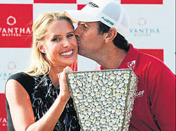 Happy couple: Thomas Aiken kisses his wife Kate after winning the Avantha Masters in Greater Noida on Sunday. AFP