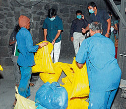 Violation:  Medical education and district in-charge minister S&#8200;A&#8200;Ramdas and deputy commissioner Ramegowda inspect the waste at a private bio-medical waste management unit in Mysore on Sunday. dh photo