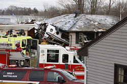 The front end of a Hawker Beachcraft Premier jet sits in a room of a home on Iowa Street in South Bend, Ind., Sunday, March 17, 2013. Authorities say a private jet apparently experiencing mechanical trouble crashed resulting in injuries. Federal Aviation Administration spokesman Roland Herwig says the Beechcraft Premier I twin-jet had left Tulsa, Okla.'s Riverside Airport and crashed near the South Bend Regional Airport on Sunday afternoon. AP Photo