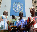 Demonstrators hold portraits of missing relatives during a protest outside the United nations office in Colombo on March 13, 2013. A Roman Catholic priest led families of victims to hand over a petition to the UN office as Sri Lanka faced renewed censure at the on-going UN Human Rights Council (UNHRC) sessions in Geneva. Priest Sebamalai Emmanual said hundreds of minority Tamils were stopped from leaving the northern town of Vavuniya a week ago by police and security forces who blocked a planned peaceful demonstration in the capital. AFP PHOTO