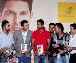 Members of Indian cricket team at the launch of the book of 'Yuvraj Singh' in New Delhi on Tuesday. PTI Photo