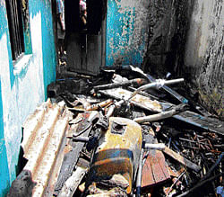 Materials, including windows, doors, gutted due to short circuit at a house at Subhash Nagar in Malur on Tuesday. DH Photo