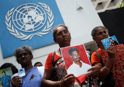 Sri Lankan demonstrators hold portraits of missing relatives during a protest outside the United nations office in Colombo on March 13, 2013. A Roman Catholic priest led families of victims to hand over a petition to the UN office as Sri Lanka faced renewed censure at the on-going UN Human Rights Council (UNHRC) sessions in Geneva. Priest Sebamalai Emmanual said hundreds of minority Tamils were stopped from leaving the northern town of Vavuniya a week ago by police and security forces who blocked a planned peaceful demonstration in the capital. AFP PHOTO
