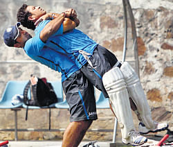 lifting the batting behemoth!: Ajinkya Rahane helps Sachin Tendulkar stretch during Indias training session on Thursday at the Feroz Shah Kotla ahead of the fourth Test against Australia, beginning on Friday. pti