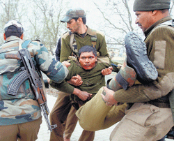 Back to basics Paramilitary CRPF men carry a wounded comrade after a fidayeen attack on the outskirts of Srinagar. Photo/ SHAHID TANTARY