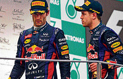 no champagne moment this: Red Bulls Sebastian Vettel (right) is given cold shoulder by team-mate Mark Webber. AFP