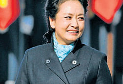 Peng Liyuan smiles after arriving in Moscow. AP