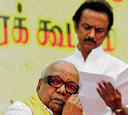 DMK&#8200;chief M Karunanidhi wipes his face as his son M K Stalin looks at a paper as they attend their party's executive meeting in Chennai on Monday. REUTERS photo