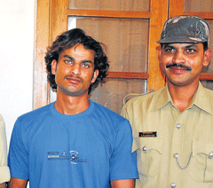 nabbed: Saligrama police seen with the accused Revanna at the office of SP&#8200;in Mysore on Wednesday.  dh photo