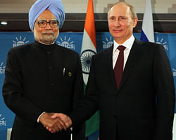 Prime Minsiter Manmohan Singh shakes hands with Russian President V Putin during a bilateral meeting ahead of the BRICS 5 Summit in Durban, South Africa on Tuesday. PTI Photo
