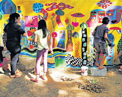 CAMARADERIE OF COLOURS: Painting a BBMP park boundary wall in big, bold Hundertwasser designer colours, children make a bold statement. The park is in Defence Colony, Indiranagar.