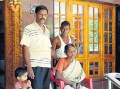 Family members of Krishnayya Mogaveera (inset) at their home in Balkur. DH photo