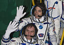 Russian Cosmonaut Pavel Vinogradov, bottom, and U.S. astronaut Christopher Cassidy, crew members of the mission to the International Space Station (ISS), wave prior to the launch of Soyuz-FG rocket at the Russian leased Baikonur Cosmodrome, Kazakhstan, Thursday, March 28, 2013. (AP Photo