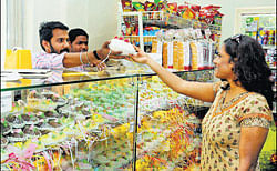 Festivity: A customer buying Easter eggs at Thoms Cafe on St Johns Road.  DH Photo by Dinesh S K