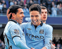 Manchester Citys Carlos Tevez (left) celebrates with Samir Nasri after scoring against New Castle United during their EPL match on Sunday. AFP