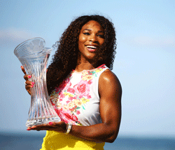 Serena Williams of the USA poses with the winners trophy at Crandon Park beach after defeating Maria Sharapova of Russia after the Womens Final match of the Sony Open on Day 13 at Crandon Park Tennis Center in Key Biscayne, Florida. AFP Photo