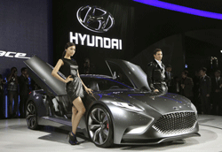 South Korean models pose with a Hyundai Motors 'HND-9 Venace' during a press day of the Seoul Motor Show in Goyang, South Korea, Thursday, March 28, 2013. The exhibition, with 384 companies from 14 countries to participate, will be held from March 29 through April 7. AP Photo